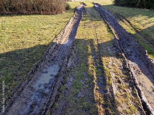 spring rains waterlogged the soil profile and lawns and meadows are mud traps for heavy vehicles. impenetrable by spring snowmelt. the rutted tracks of the car that came back photo