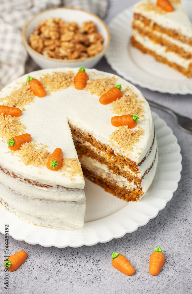 Homemade carrot cake made with walnuts, iced with cream cheese. Sweet dessert. Homemade carrot cake made with walnuts, iced with cream cheese. Sweet dessert.