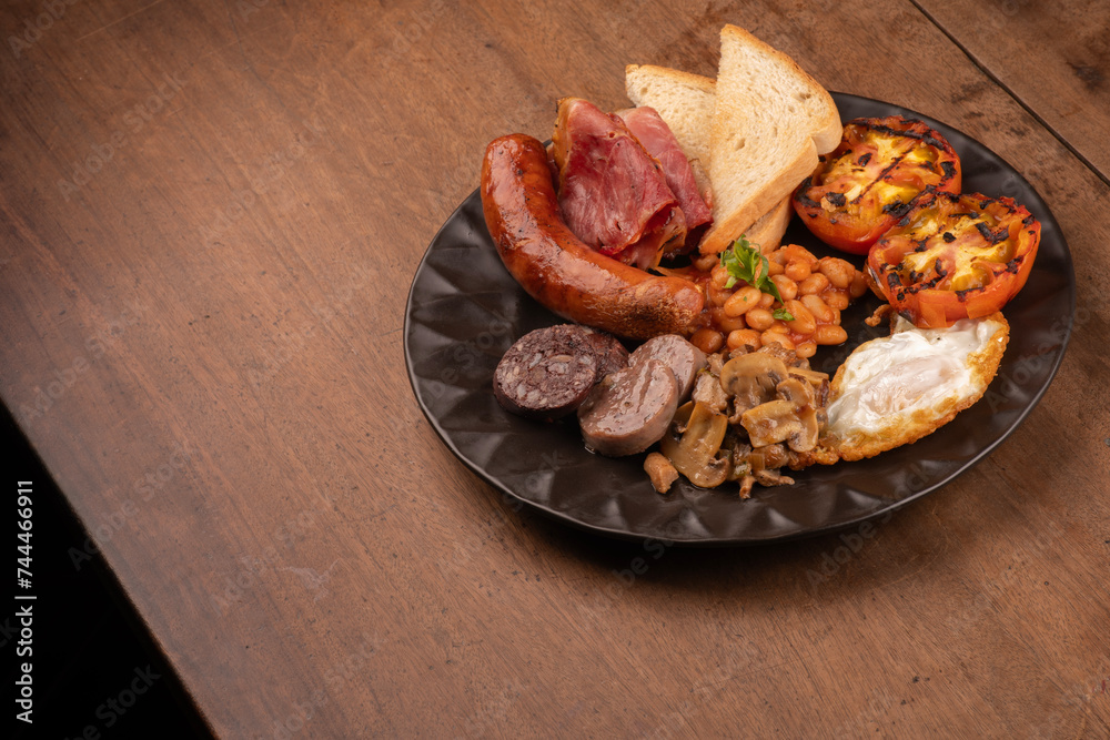 Fototapeta premium english breakfast irish uk with plenty of protein sweet beans sausage bacon egg mushrooms wooden table
