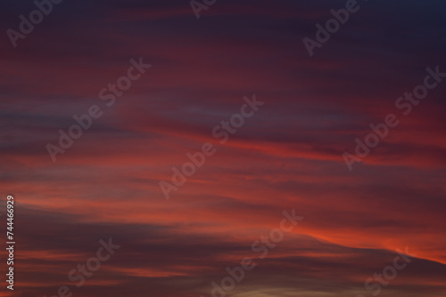 Dramatic sunset with vibrant clouds lit by a sun