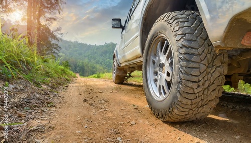 Exploring the Outdoors: Detailed Shots of SUV Wheels Conquering Dirt Roads"