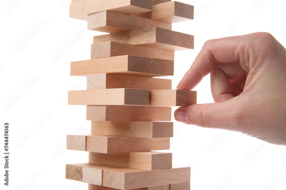 Woman playing Jenga on white background, closeup Woman playing Jenga on white background, closeup