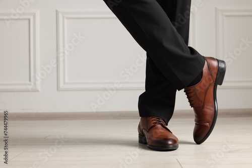 Businessman in elegant leather shoes indoors, closeup. Space for text