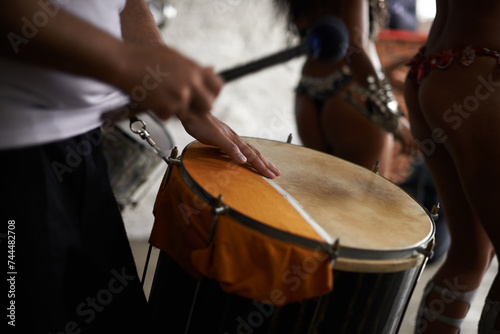 Drummer, hands and music with percussion drums on stage, rhythm and person with talent in band. Creative people, beat and performing in group as professional musician and energy for entertainment