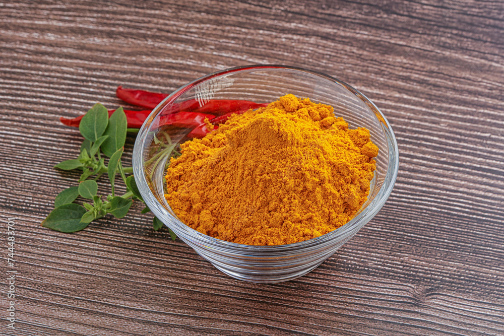 Yellow vibrant curcuma powder in the bowl Yellow vibrant curcuma powder in the bowl