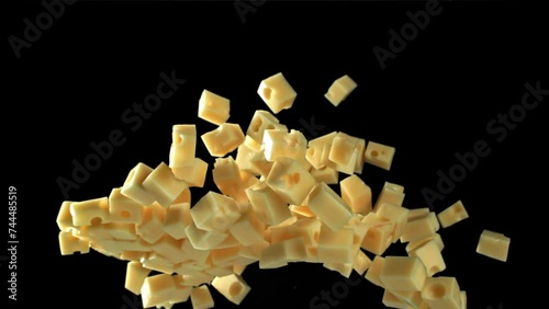 Super slow motion pieces of cheese on black background. Filmed on a high-speed camera at 1000 fps. High quality FullHD footage photo