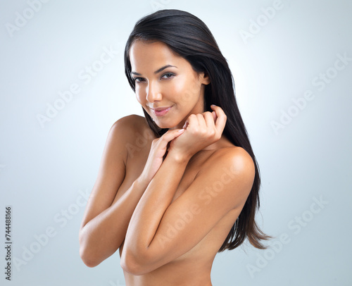 Portrait  woman and hand on body for skincare  bodycare or dermatology in studio on white background. Nude  female person or glow with moisturizing for hydration  flawless skin and wellness treatment