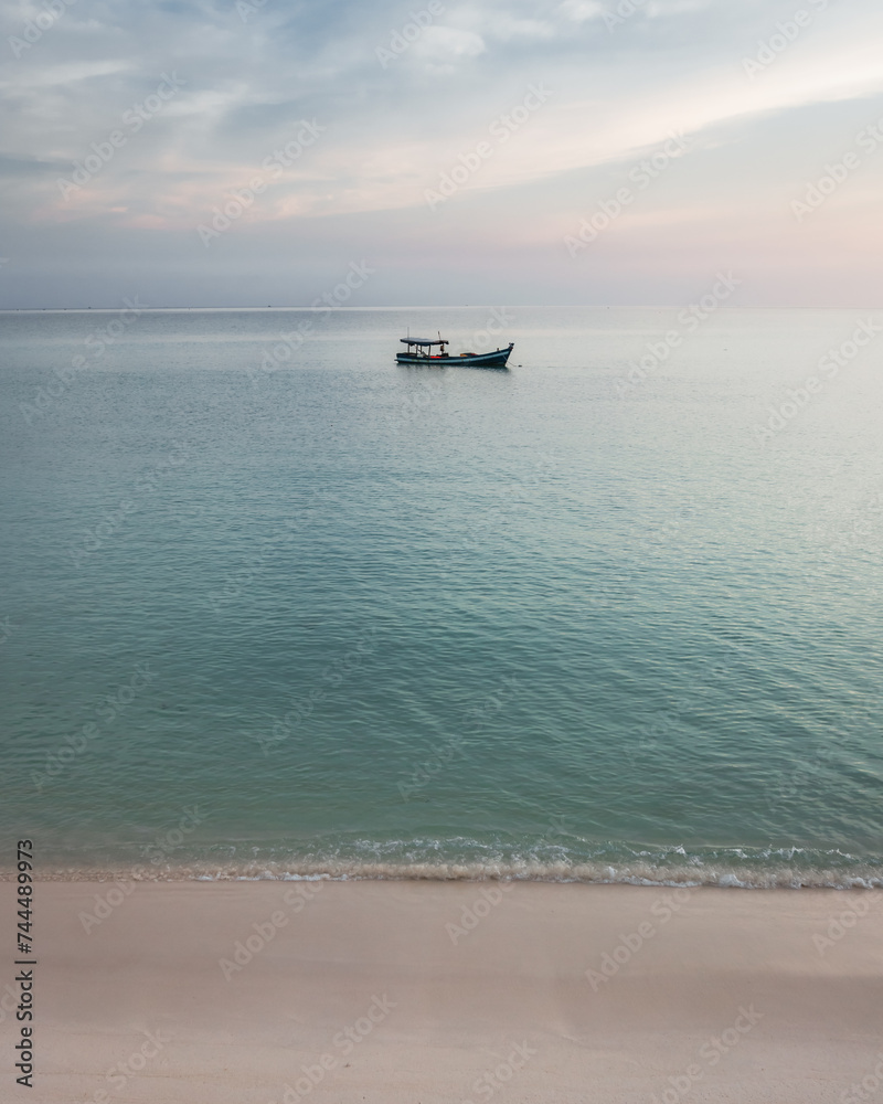A small fishing boat out in the calm sea