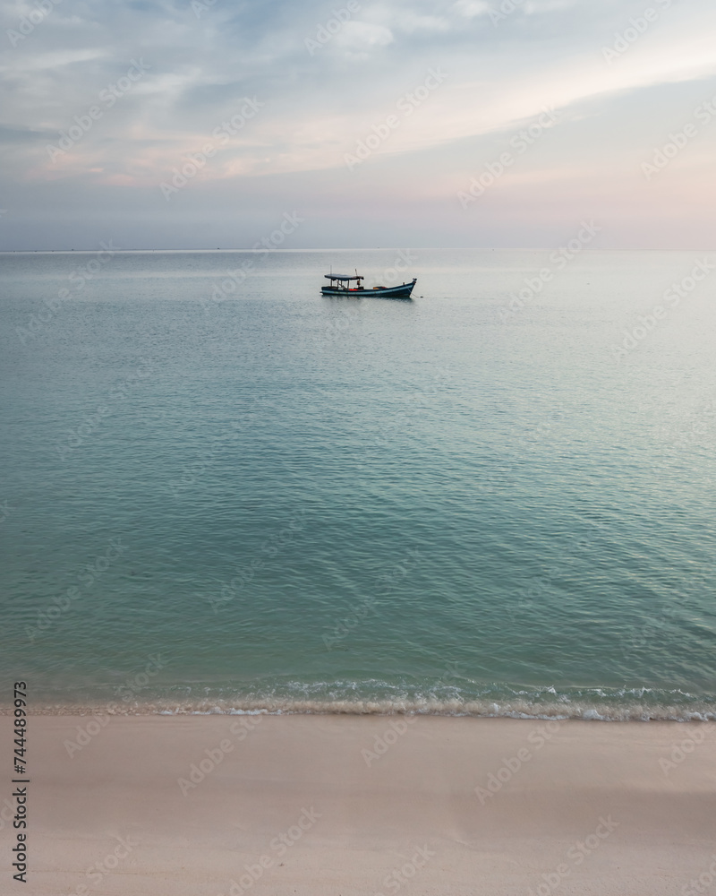 A small fishing boat out in the calm sea A small fishing boat out in the calm sea