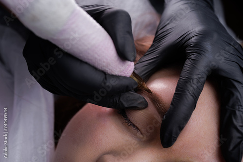 Technique of air application of permanent makeup on the model s eyebrows. PMU Procedure  Permanent Eyebrow Makeup.