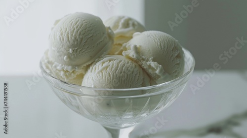 A delectable arrangement of vanilla ice cream scoops served in a glass bowl, their creamy goodness standing out against the pure white canvas, captured in exquisite detail by the HD camera.