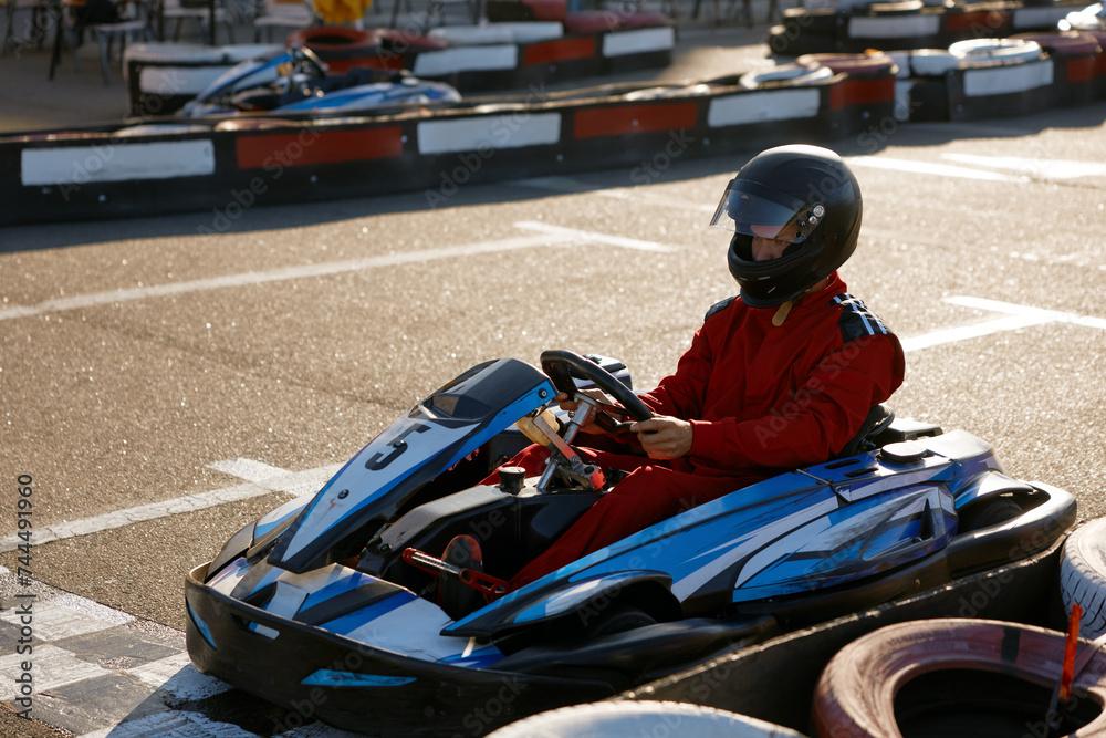 Diver racing on go-cart track outdoors enjoying competitive activity