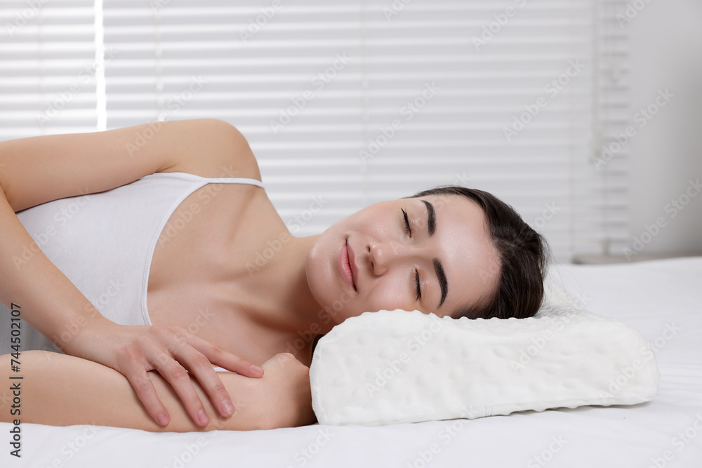 Woman sleeping on orthopedic pillow at home Woman sleeping on orthopedic pillow at home