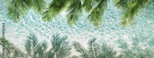 Shade of lush palm leaves in crystal clear water. Tropical vibes. Travel agency banner