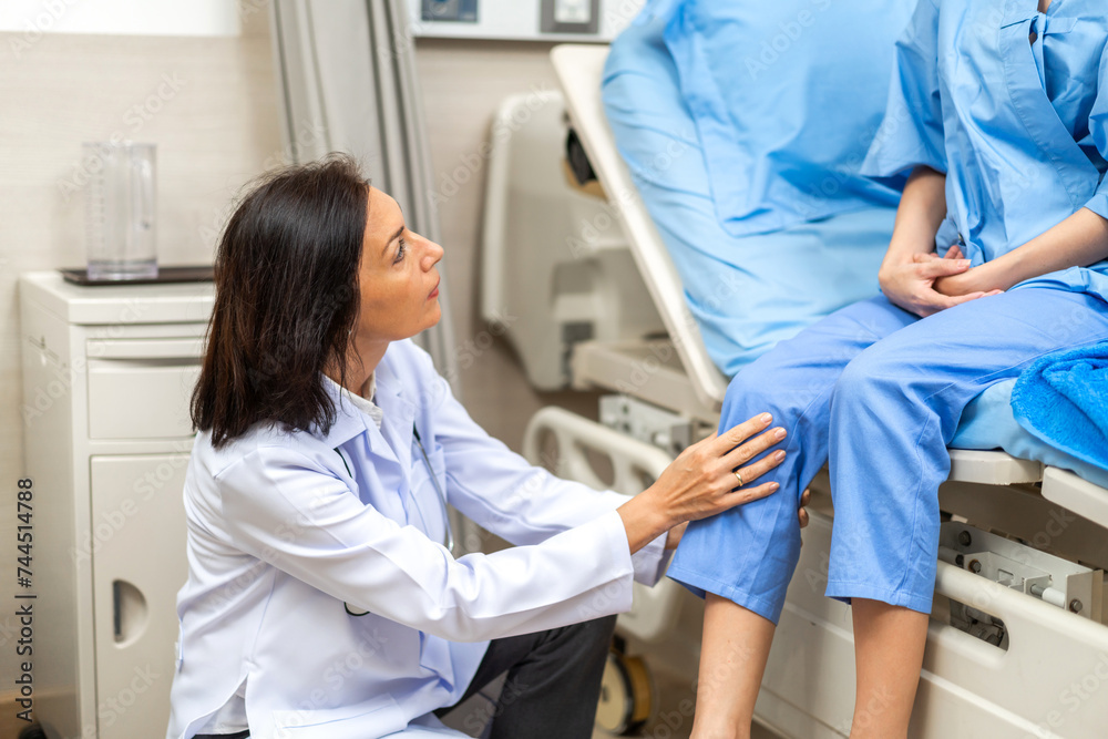 Portrait of smiling caring senior doctor trainer carer helping physical discussing and consulting taking care with sick woman patien doing exercises at hospital.care and insurance concept Portrait of smiling caring senior doctor trainer carer helping physical discussing and consulting taking care with sick woman patien doing exercises at hospital.care and insurance concept
