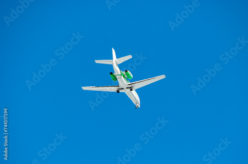 Airplane in the blue sky viewed from below