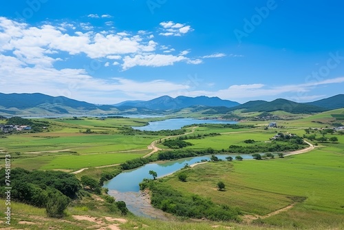 Nuclear power plant surrounded by scenic landscape featuring lush fields and beautiful blue sky