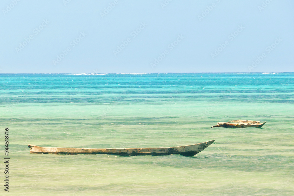 Obraz premium Scenic view of moored boats at Jambiani beach, Zanzibar