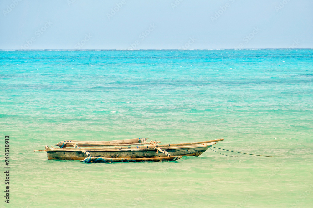 Obraz premium Scenic view of moored boat at Jambiani beach, Zanzibar