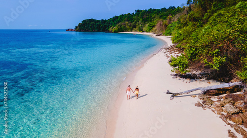 a couple walking at the beach of Koh Kradan Island in Thailand