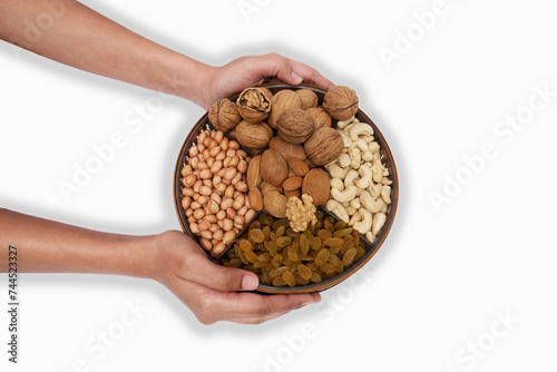 Embracing Health: Hands Holding a Bowl of Assorted Nuts and Dried Fruits, This image features a pair of hands gracefully holding a wooden bowl filled with an assortment of nuts and dried fruits.