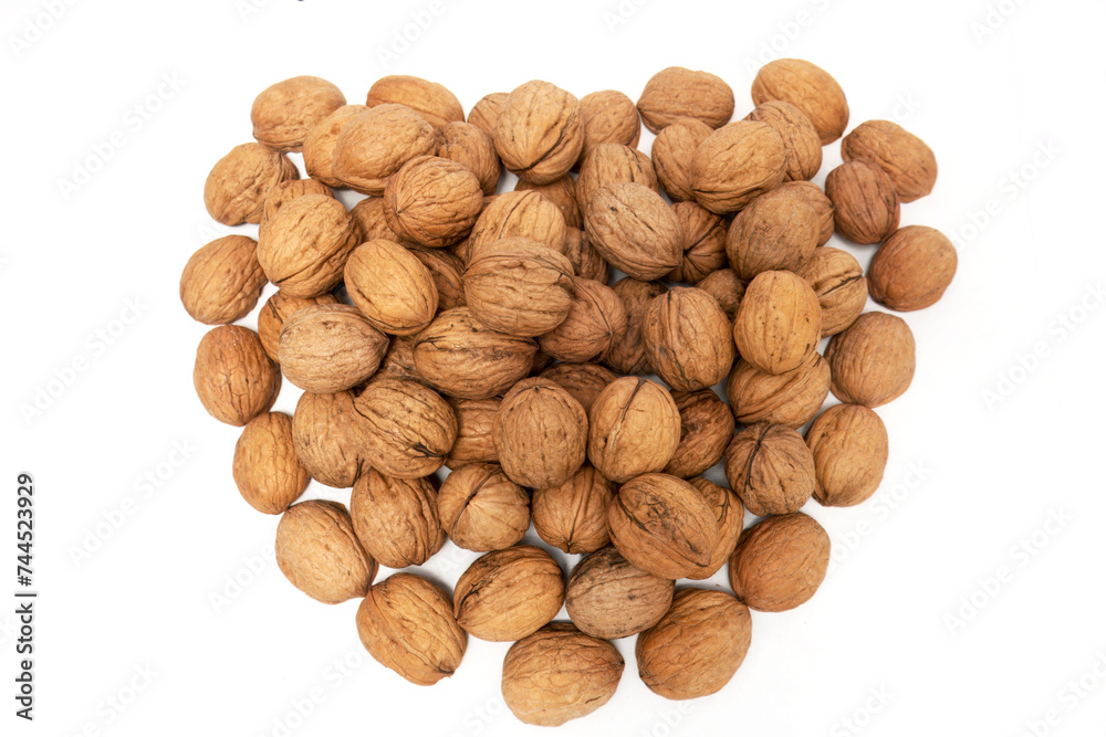Nature's Gift: Fresh Organic Walnuts in Heart Shape, A striking image capturing a heart shape amidst a scattered pile of fresh, organic walnuts. Against a clean white background, the brown walnuts Nature's Gift: Fresh Organic Walnuts in Heart Shape, A striking image capturing a heart shape amidst a scattered pile of fresh, organic walnuts. Against a clean white background, the brown walnuts