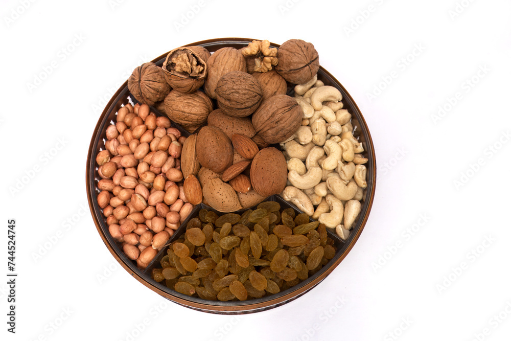 Nutritious Array: Assorted Nuts and Dried Fruits on a Round Tray, This image presents a round tray filled with a variety of nuts and dried fruits, neatly arranged in four sections. Nutritious Array: Assorted Nuts and Dried Fruits on a Round Tray, This image presents a round tray filled with a variety of nuts and dried fruits, neatly arranged in four sections.
