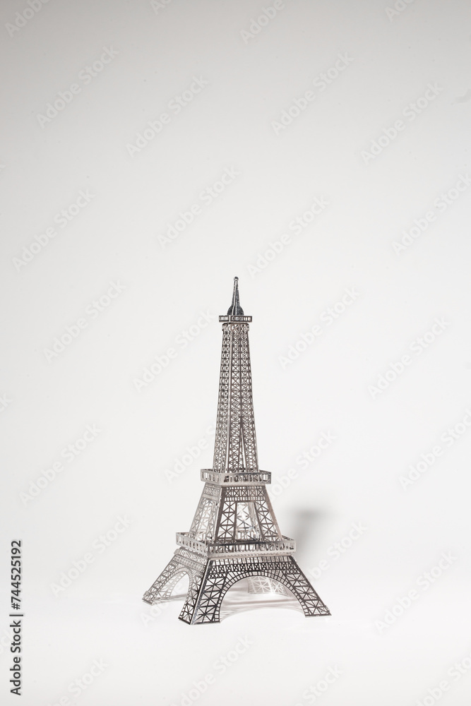 Delicate metal Eiffel Tower model on white background