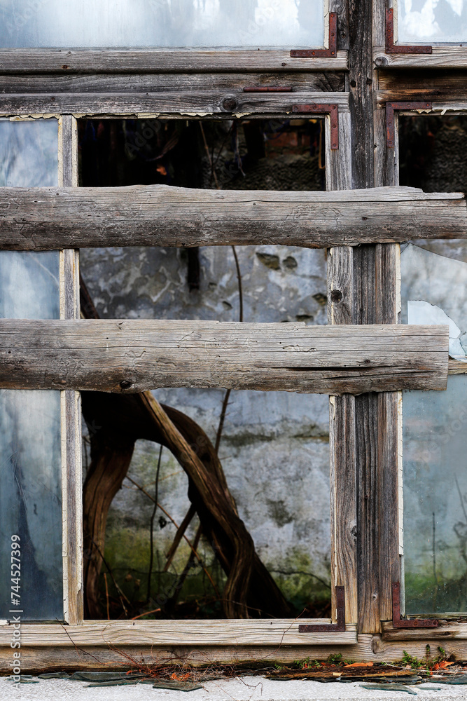Broken window boarded up. Ruined, abandoned building. Broken window boarded up. Ruined, abandoned building.