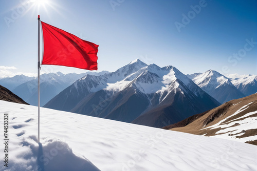 A red flag on snowy mountain peak, background for business achievements concept