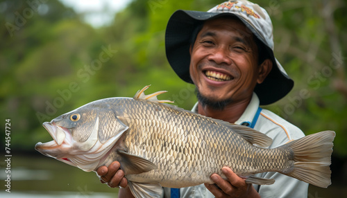 Male fisherman with a catch of fish in his hands