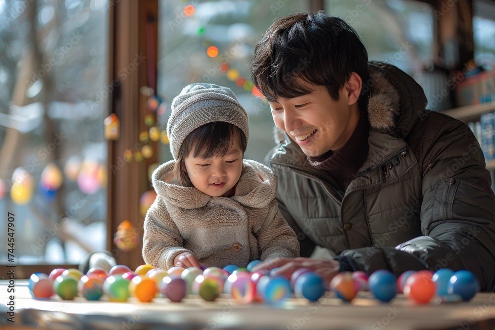 Man Playing With Child in Front of Table Man Playing With Child in Front of Table
