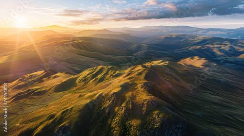A breathtaking aerial view of a vast mountain range at sunrise. © Damian