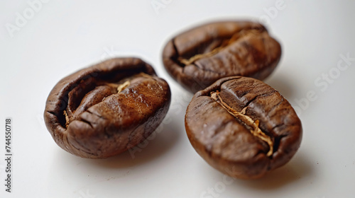 Roasted coffee beans on a white background.