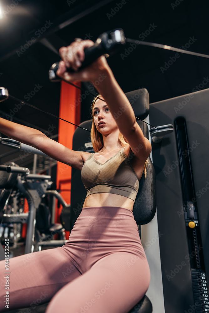 Beautiful skinny redhead woman exercising in a spacious and modern equipped fitness gym. People and recreation concept. Beautiful skinny redhead woman exercising in a spacious and modern equipped fitness gym. People and recreation concept.