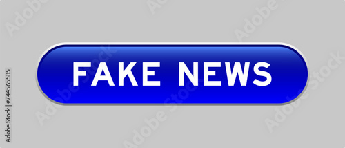 Blue color capsule shape button with word fake news on gray background