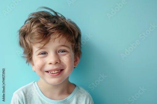 Portrait of 10 years old boy with beautiful face on blue background