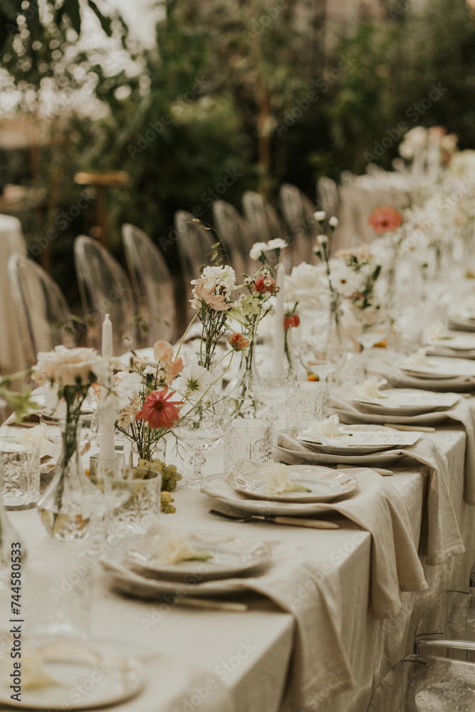 Modern stylish wedding table setting. The wedding decor. The pastel colors flowers bouquet. Natural beautiful wedding decorations. Minimalistic wedding decorations
