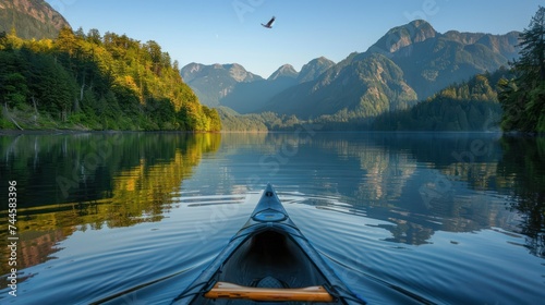 Blue Kayaking at Sunrise in Mountain Lake Scenery © happysunstock