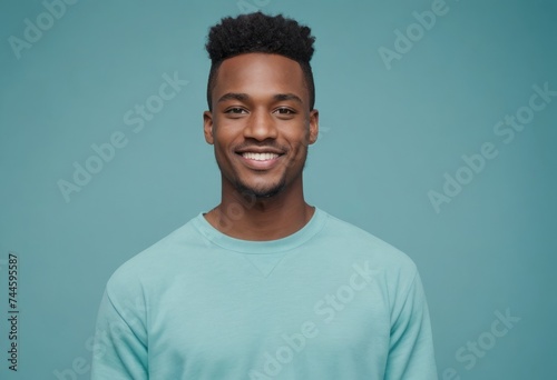 A friendly African American man in a teal shirt, his confident smile exuding warmth and approachability.