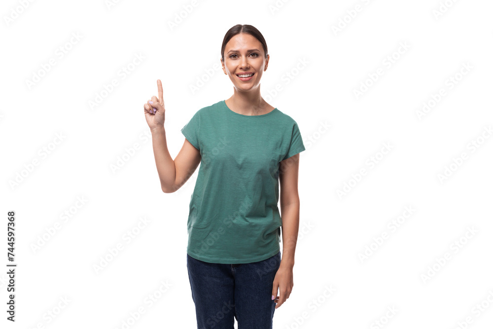 a young woman with black hair and a slender figure dressed in a green T-shirt attracts attention with her hands a young woman with black hair and a slender figure dressed in a green T-shirt attracts attention with her hands