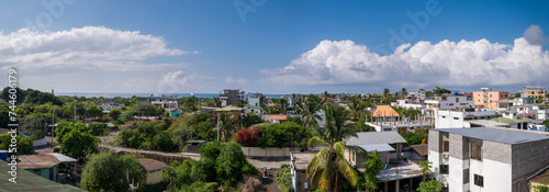 Panoramic view of the town of Santa Cruz in the Galapagos Islands. In the background you can see the sea and a sky with some clouds photo
