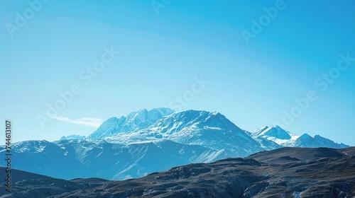 Snow Covered Mountains Skyline In Winter On Clear Blue Sky