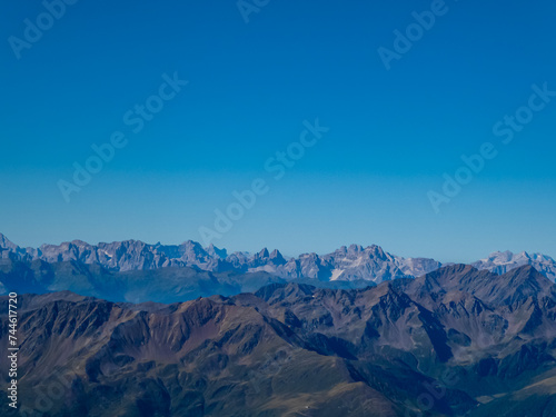 Panoramic view from majestic mountain peak of Hochschober  Schober Group  High Tauern National Park  East Tyrol  Austria. Wanderlust Austrian Alps in summer. Misty rugged ridges against clear blue sky