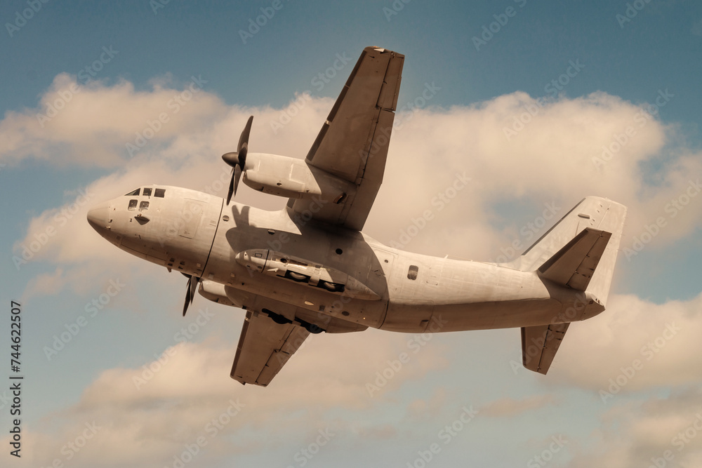 Military propeller airplane against cloudy sky Military propeller airplane against cloudy sky