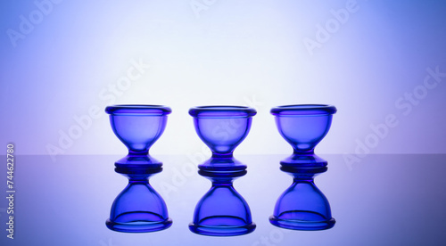 Elegant blue glass tableware on softly glowing gradient backdrop