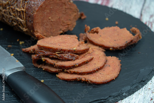 Vegan netted ham mock meat loaf on slate board