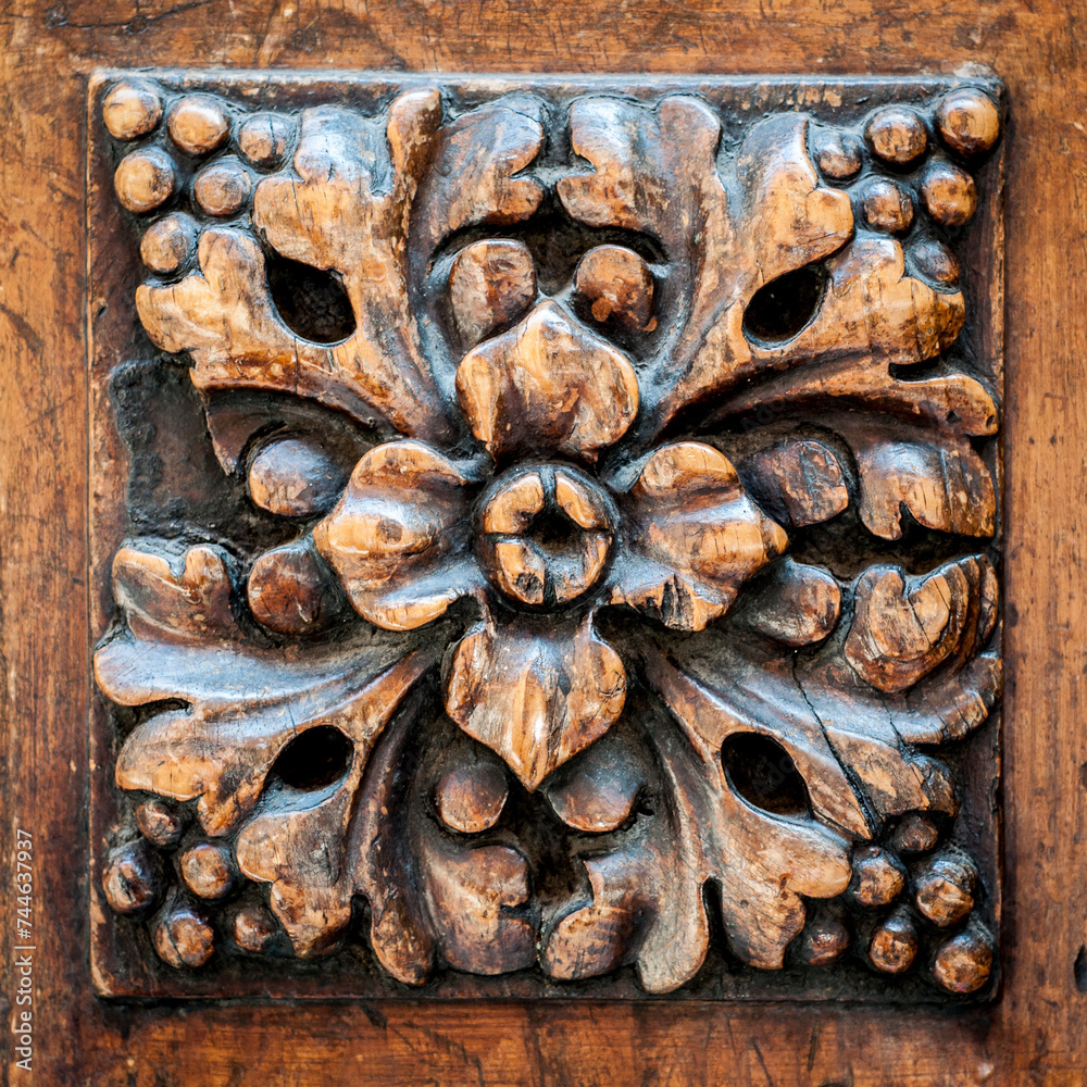 Delicate Bloom: Woodcarving of a Flower in Rustic Relief