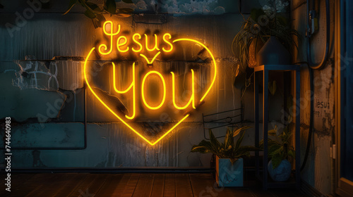 Illuminated Yellow Neon Sign Declaring Jesus Loves You, with Heart Shape Symbol / Icon and Dark Grey Wall Background and Dim Lighting photo