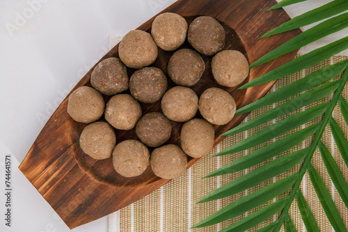 Fresh home made urad dal and millet laddu isolated and decorated. Locally called Urad Dal Ladoo, Ulundu urundan, Ulundu laddu, Kambu laddu. Selective focused millet ladoo. photo